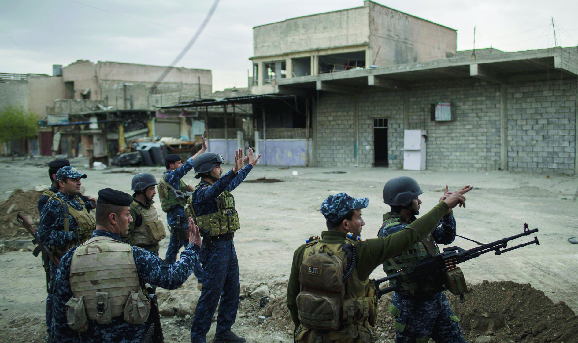 Federal Police soldiers gesture to other soldiers near the old city, during fighting against Islamic State militants on the western side of in Mosul, Iraq, Tuesday, March 28, 2017. (AP Photo/Felipe Dana) Iraq Mosul