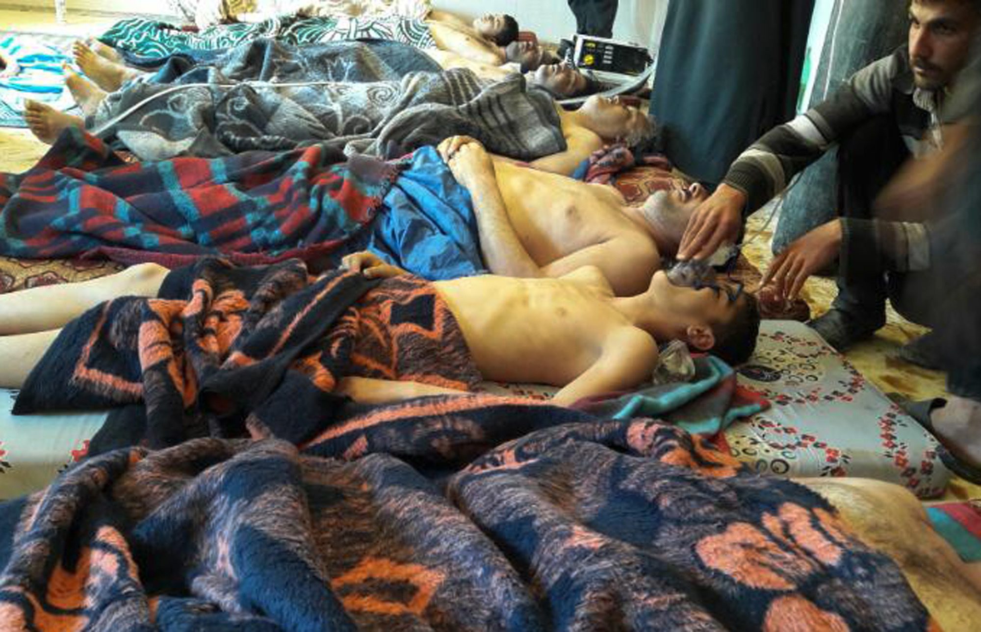 FILE -- In this Tuesday, April 4, 2017 file photo, victims of the suspected chemical weapons attack lie on the ground, in Khan Sheikhoun, in the northern province of Idlib, Syria. France's foreign minister says chemical analysis of samples taken from a deadly sarin gas attack in Syria shows that the nerve agent used "bears the signature" of President Bashar Assad's government and shows it was responsible. Jean-Marc Ayrault says France now knows "from sure sources" that "the manufacturing process of the sarin that was sampled is typical of the method developed in Syrian laboratories." But Kremlin promptly denounced the French report. (Alaa Alyousef via AP, File) Syria