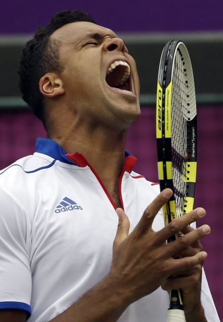 Jo-Wilfried Tsonga of France screams after losing a point to Milos Raonic at the All England Lawn Tennis Club at Wimbledon, in London, at the 2012 Summer Olympics, Tuesday, July 31, 2012. (AP Photo/Mark Humphrey)