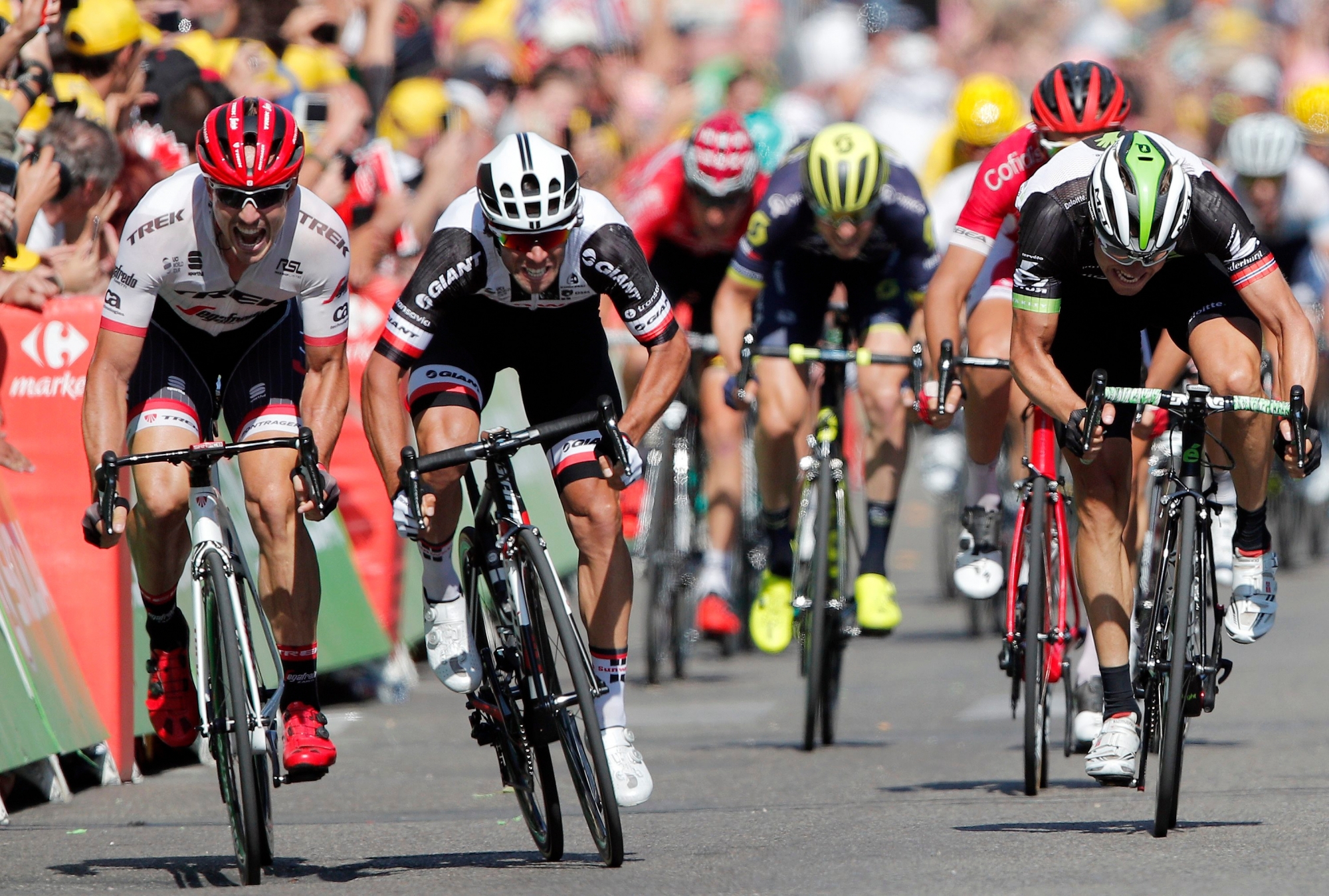 Australia's Michael Matthews, center left, crosses sprints to win the sixteenth stage of the Tour de France cycling race over 165 kilometers (102.5 miles) with start in Le Puy-en-Velay and finish in Romans-sur-Isere, France,, Tuesday, July 18, 2017. Norway's Edvald Boasson Hagen, right, finished second and Germany's John Degenkolb third. (AP Photo/Christophe Ena) FRANCE CYCLING TOUR DE FRANCE