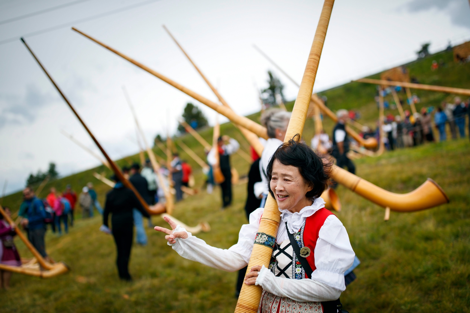 A Japanese alphorn player leaves after taking part in a group performance during the 16th international alphorn festival in Nendaz, south western Switzerland, Sunday July 23 2017. Over 180 alphorn players performed in Nendaz over the three day-long festival. (KEYSTONE/Valentin Flauraud) SWITZERLAND ALHORN FESTIVAL
