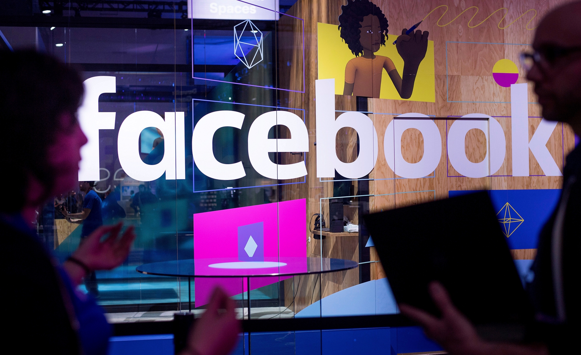 FILE - In this April 18, 2017, file photo, conference workers speak in front of a demo booth at Facebook's annual F8 developer conference in San Jose, Calif. Facebook said Thursday, Jan. 11, 2018, that it is tweaking what people see to make their time on it more Äúmeaningful.Äù The changes come as Facebook faces criticism that social media can make people feel depressed and isolated. (AP Photo/Noah Berger, File) Facebook News Feed Changes