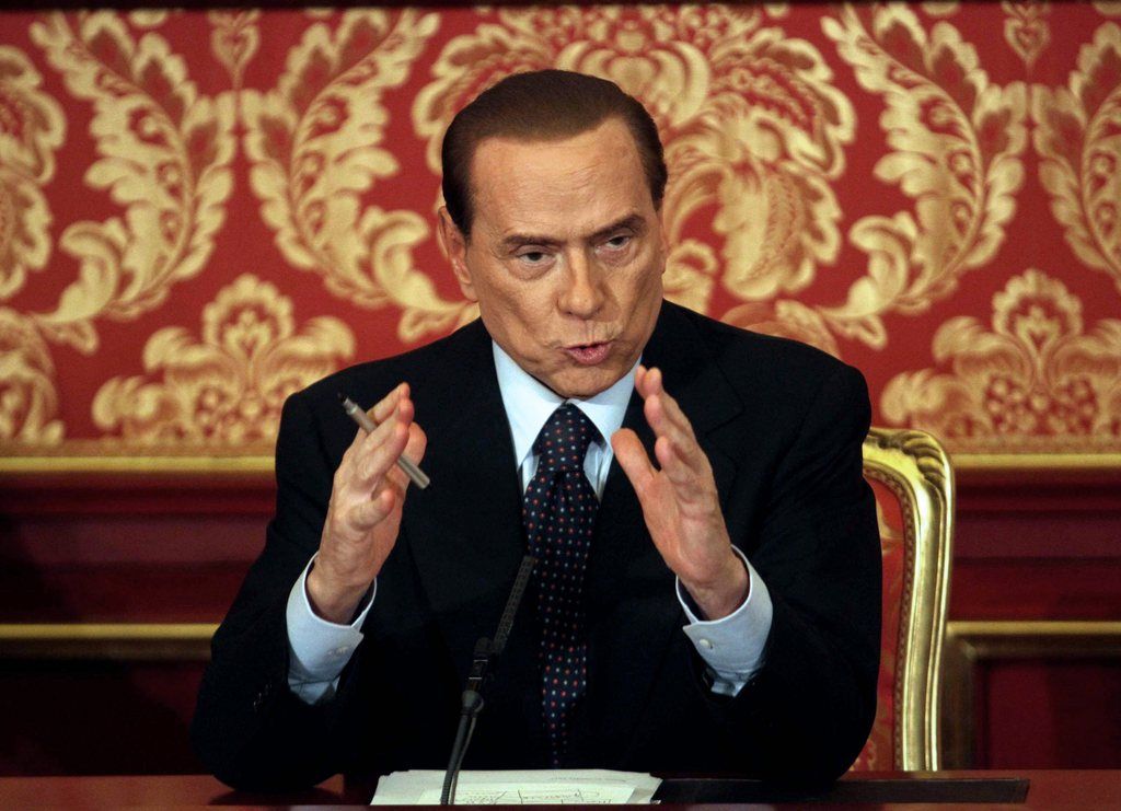 epa03449226 Former Italian premier Silvio Berlusconi talks to media during his press conference at 'Villa Gernetto' in Gerno di Lesmo,  Monza, 27 October 2012. Berlusconi confirmed that he is not going to run for Italian Premier. A court in Milan on 26 October sentenced former Italian premier Silvio Berlusconi to four years' imprisonment for tax evasion - but it was almost immediately cut to one year after judges said he won a three-year remit on his conviction thanks to a 2006 pardon law. The law was passed by parliament when Berlusconi's centre-left opponent, Romano Prodi, headed the Italian government. It was adopted to tackle massive overcrowding in Italy's prisons.  EPA/STEFANO PORTA  EPA/STEFANO PORTA