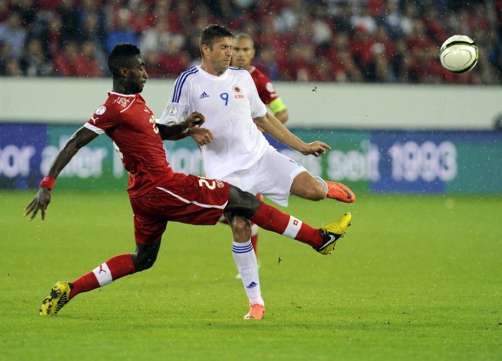 Switzerland's Johan Djourou, left, fights for the ball with Albania's Edgar Cani during a Worldcup qualification soccer match between Switzerland and Albania at the Swisspor Arena in Lucerne, Switzerland, Tuesday, September 11, 2012. (KEYSTONE/Sigi Tischler)
