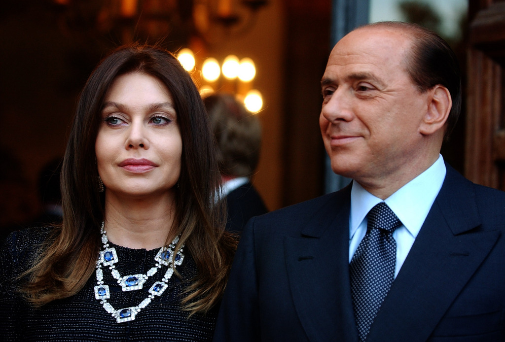 FILE -  In this Friday June 24, 2004 file photo, Italian premier Silvio Berlusconi, right, and his wife Veronica Lario wait for President George W. Bush and first lady Laura Bush at the Villa Madama residence in Rome. An Italian newspaper has reported, Friday, Dec. 28, 2012, the details of the divorce settlement between ex-Premier Silvio Berlusconi and his second wife Veronica Lario, saying he must pay her ?3 million ($4 million) a month alimony but gets to keep their estate. Lario announced she was divorcing the billionaire media mogul in 2009, citing his presence at the 18th birthday party of a Naples girl and his fondness for younger women. The couple met in a dressing room in 1980 after Berlusconi saw Lario perform in a Milan theater, were married in 1990 and have three grown children. He has two children from his first marriage. The 76-year-old Berlusconi is currently dating a woman nearly 50 years his junior. (AP Photo/Susan Walsh, File)