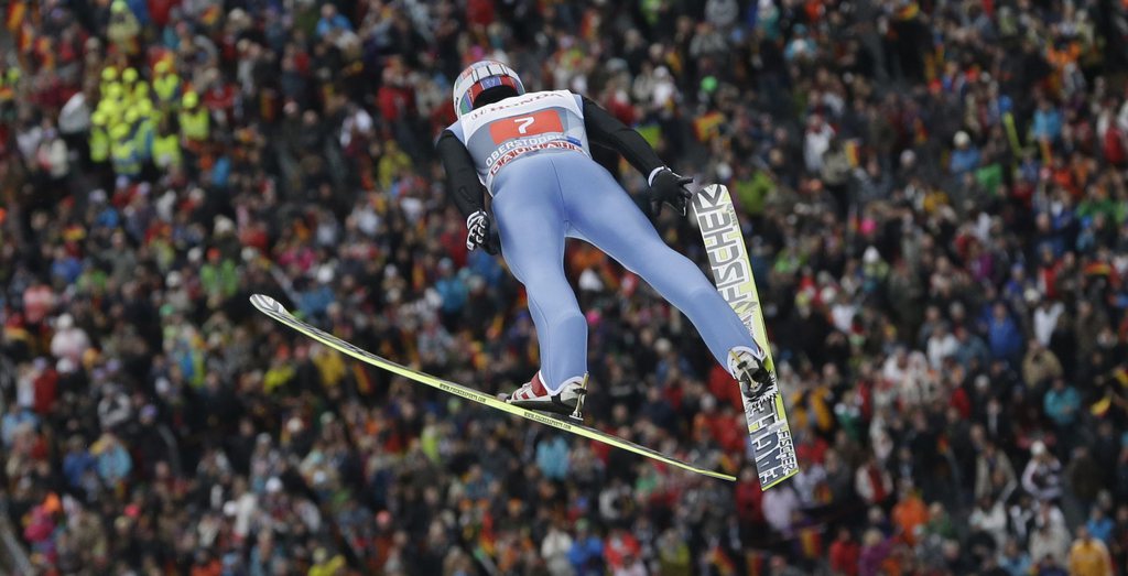 Switzerland's Simon Ammann soars through the air during his trial jump at the first stage of the four hills ski jumping tournament in Oberstdorf, southern Germany, Sunday, Dec. 30, 2012. (AP Photo/Matthias Schrader)