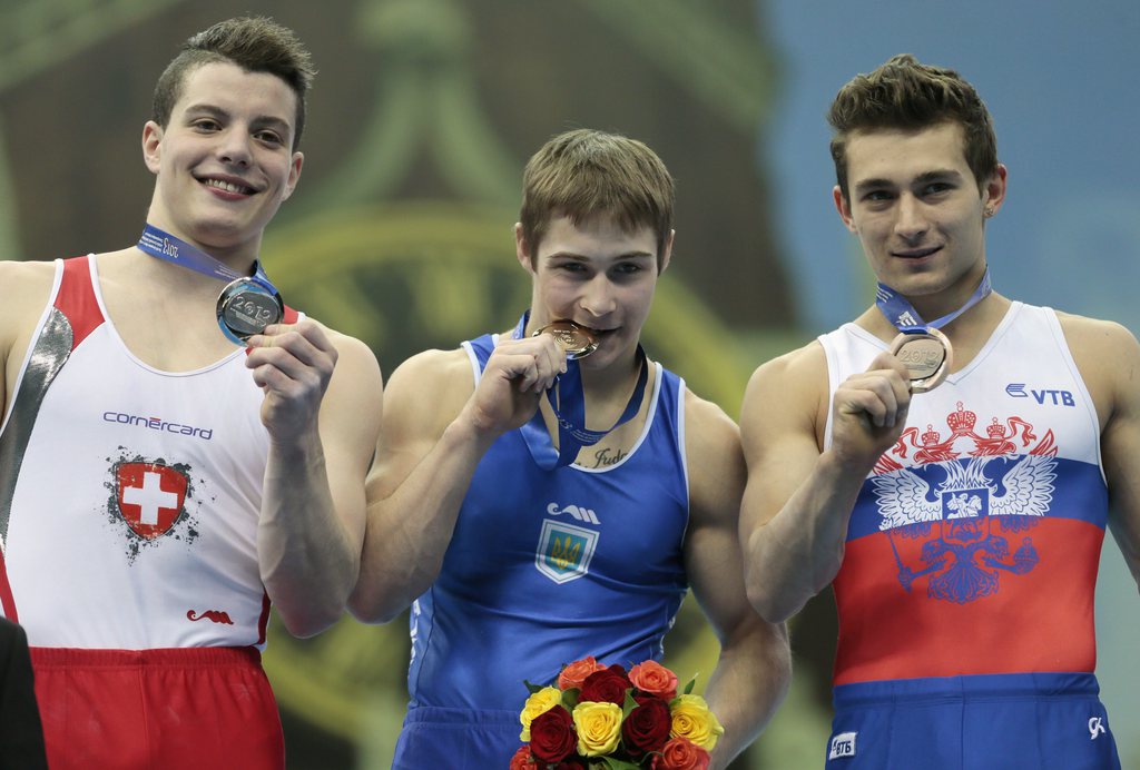 From left, silver medal winner Lucas Fischer of Switzerland, gold medal winner Oleg Stepko of Ukraine, and bronze medal winner David Belyavskiy of Russia pose on the podium  after performing on the parallel bars at the men's Apparatus Final of the Artistic Gymnastics European Championships in Moscow, Russia, Sunday, April 21, 2013. (AP Photo/Mikhail Metzel)