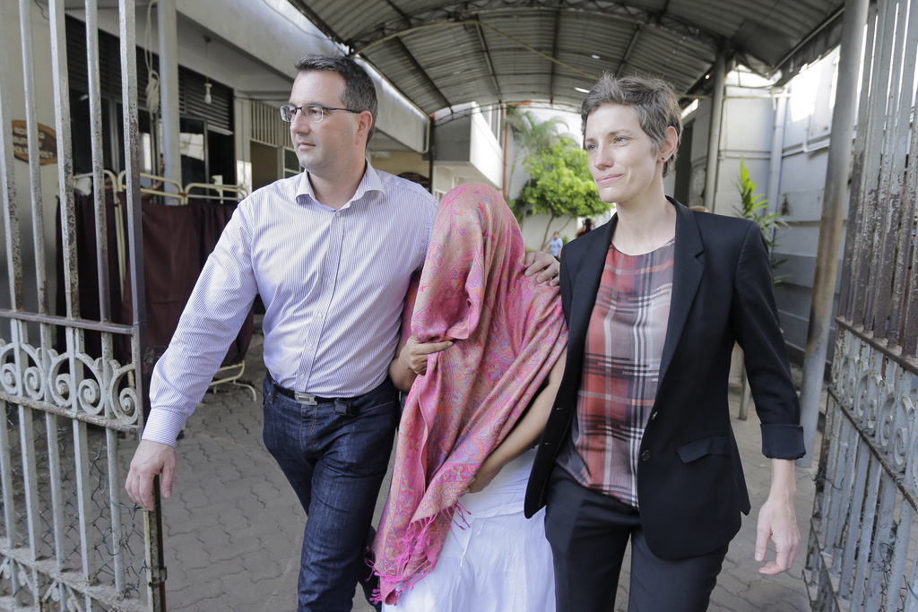 epa08094781 Swiss embassy personnel accompany staff member Garnier Banister Francis (C) out of the court premises after she was granted bail in Colombo, Sri Lanka, 30 December 2019. A female staffer of the Swiss Embassy in Colombo has been arrested on order by the Attorney General, weeks after having claimed that she had been abducted and questioned about embassy related issues. Francis is charged with 'disaffection on the government and fabricating false evidence', according to the Attorney General's office. Garnier Banister Francis was released on bail on 30 December. EPA/CHAMILA KARUNARATHNE