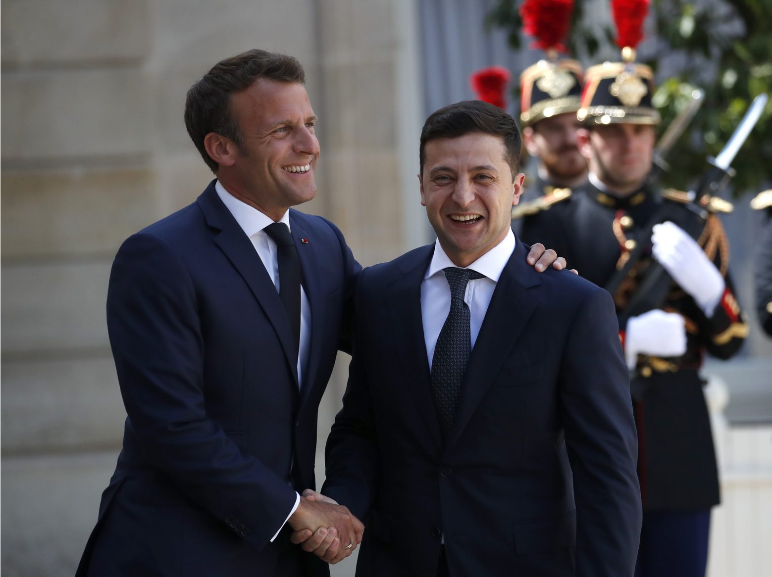 FILE In this file photo taken on Monday, June 17, 2019, French President Emmanuel Macron, right, greets Ukrainian President Volodymyr Zelenskiy before a meeting at the Elysee Palace, in Paris, France. Ukraine's president sits down Monday, Dec. 9, 2019 for peace talks in Paris with Russian President Vladimir Putin in their first face-to-face meeting, and the stakes could not be higher. More than five years of fighting in eastern Ukraine between government troops and Moscow-backed separatists has killed more than 14,000 people, and a cease-fire has remained elusive. (AP Photo/Christophe Ena, File) Ukraine's Challenges